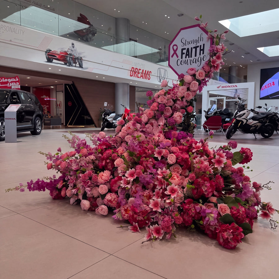 Large floral arrangement in a shopping mall with motivational quote
